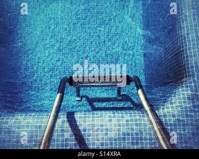 Looking at swimming pool steps Stock Photo