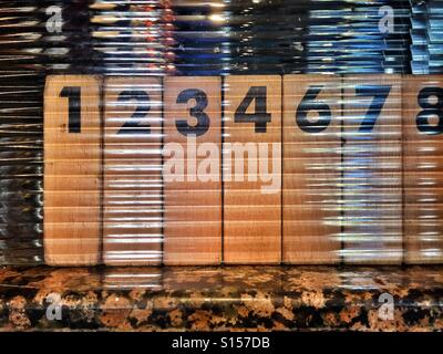 What happened to Number 5?! A row of single digit numbers written on blocks of wood. Photo Credit - © COLIN HOSKINS. Stock Photo