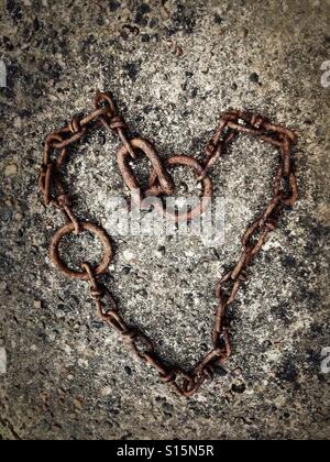 Old chain at the harbour in Buckie, Scotland, laid out in the shape of a heart. Stock Photo