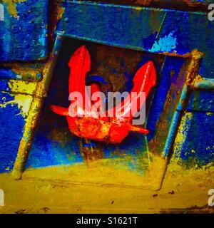 Red anchor and blue hull on an old ship, Irvine harbour, Ayrshire, Scotland Stock Photo