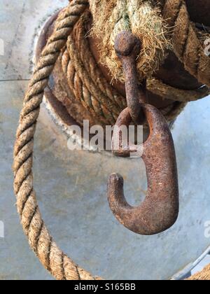 Old rusty hook and rope Stock Photo
