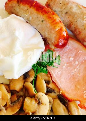 Cooked breakfast with egg, bacon, sausage and mushrooms Stock Photo