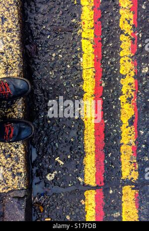 Red and yellow lines kerbside Stock Photo