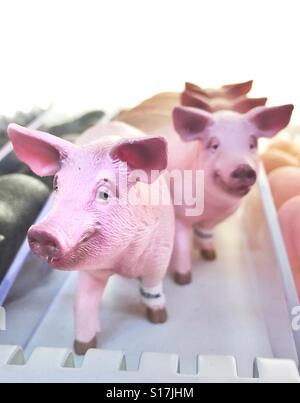 Toy pigs in a row Stock Photo