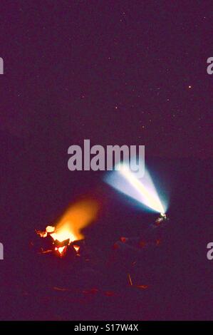 Person With Head Lamp At Campfire Stock Photo