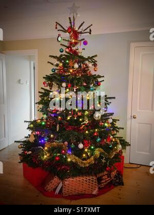 A Christmas tree on Christmas Day with presents underneath. Stock Photo