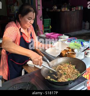 A street vendor frying a wok of PAD SEE EW (Thai Stir Fried Noodles), Chiang Rai province, Thailand Stock Photo