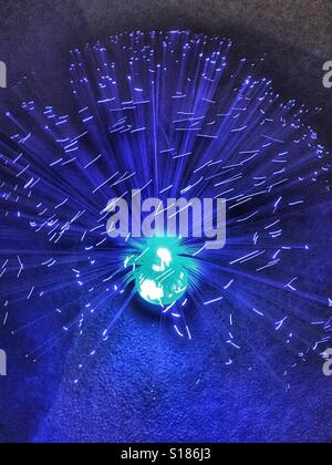 Moving blue optic fibres on an ornamental lamp Stock Photo