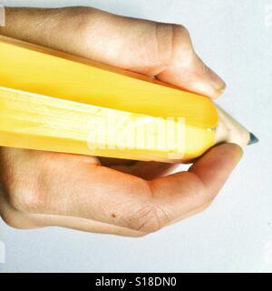 Writing with a giant pencil Stock Photo