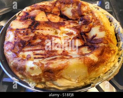 Cooking a Spanish omelette, a tortilla Stock Photo