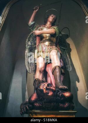 Angel and demon in San Nicolas de Bari Cathedral in Alicante, Spain Stock Photo