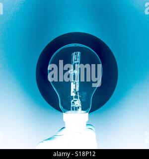 Inverted lightbulb illuminated Stock Photo