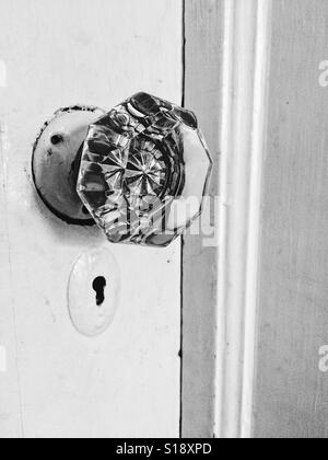 Black and white antique doorknob and keyhole in a white door Stock Photo