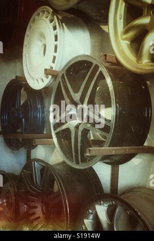 Alloy wheel hubs hanging in a workshop. Stock Photo