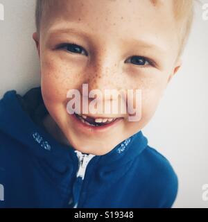 Smiling seven year old boy with missing tooth Stock Photo