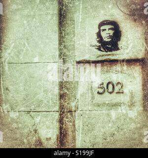 Famous photograph of Ernesto Che Guevara printed on the wall above street number in Havana, Cuba Stock Photo