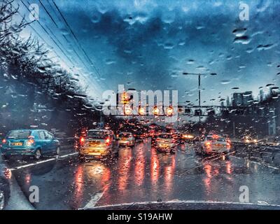 POV driving on the M6 Smart Motorway, in the rain. Speed restrictions and heavy traffic Stock Photo