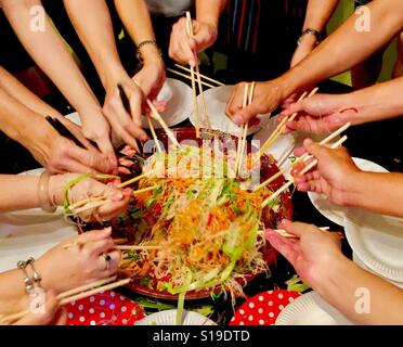 Auspicious Chinese New Year dish, Lo Hei Yu Sheng, tossing to prosperity, Singapore Stock Photo
