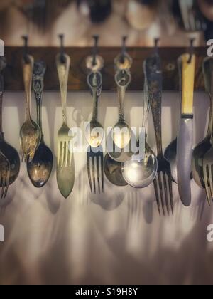Kitchen utensils hanging on a wall Stock Photo