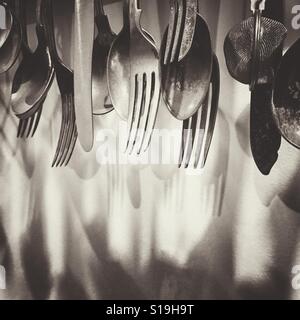 Kitchen utensils hanging on a wall Stock Photo
