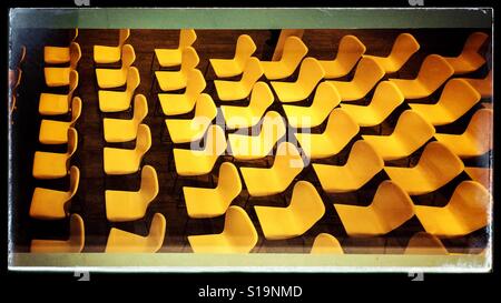Rows of yellow chairs Stock Photo