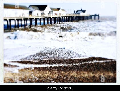 Seaside in winter. Rough sea around Southwold pier on a cold February day. Stock Photo