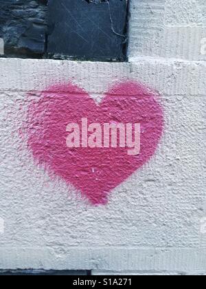 Heart graffiti sprayed onto a wall Stock Photo