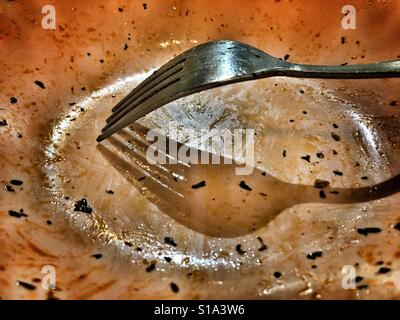 Fork in a plate after a meal. Stock Photo