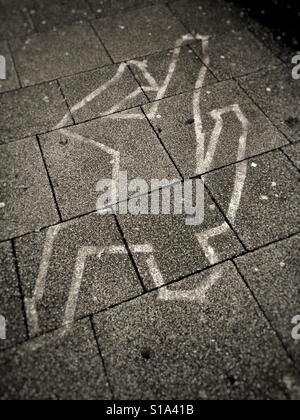 Chalk outline of body on the pavement Stock Photo