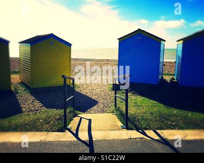 Wheelchair ramp into the beach between colourful beach huts Stock Photo