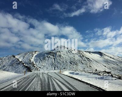 An icy road leading through Grindavik in Iceland Stock Photo