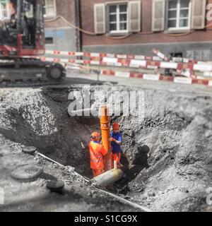 Two construction workers in a hole Stock Photo