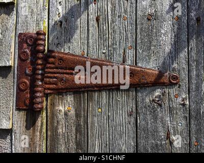Rusted hinge on an old barn door Stock Photo