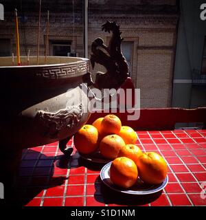 Incense and oranges on the patio of the Tin Hau Temple on Waverly in Chinatown, San Francisco, California. Stock Photo