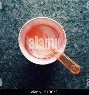 Empty ice cream cup with a plastic spoon Stock Photo