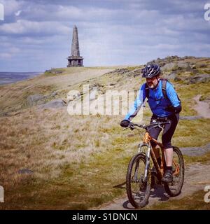 Mountain biker near Stoodley Pike monument, Calderdale, West Yorkshire. Stock Photo