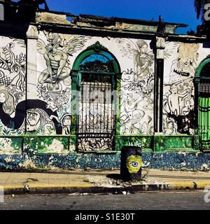 A ruined house with Spanish colonial architecture elements, painted over by a local artist, is seen in the center of San Salvador, El Salvador, 12 November 2016. Stock Photo