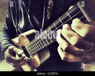 Musician playing a 5 string tenor ukulele. Double course 4th string, low g / high g Stock Photo