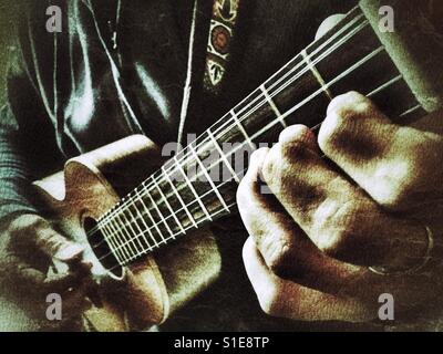 Musician playing a 5 string tenor ukulele. Double course 4th string, low g / high g Stock Photo