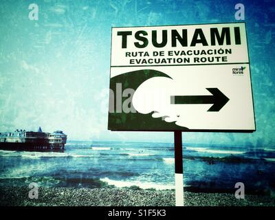 Tsunami warning sign on the beach in Lima, Peru Stock Photo