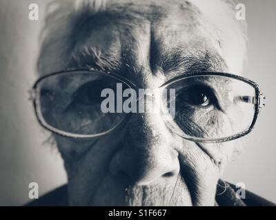 Elderly woman suffering from macular degeneration in her eyes Stock Photo