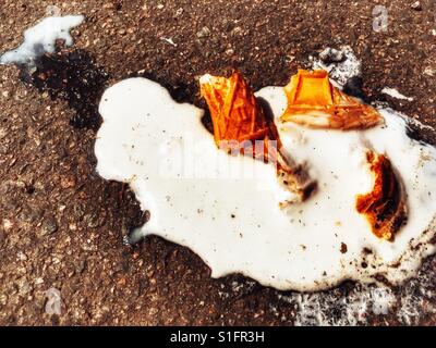 Dropped ice cream melting on the road Stock Photo