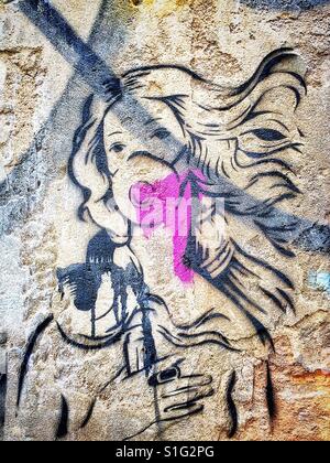 Stencil art on a wall in the Brick Lane area of London's East End Stock Photo