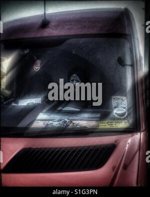 Scary mask in a van Stock Photo