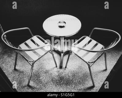 Metal chairs and table in black and white Stock Photo