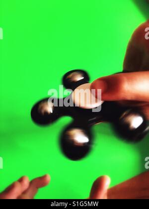 Fidget spinner spinning in a boy's hand Stock Photo