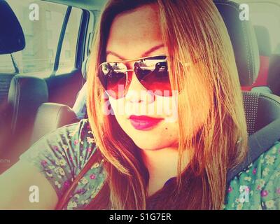 Portrait of an Asian lady in a car. Stock Photo