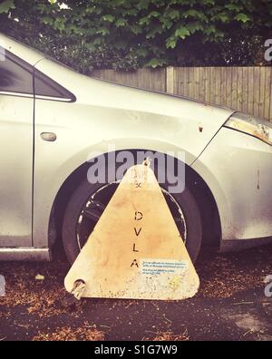 Wheel clamp on an illegally parked car Stock Photo