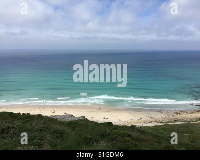 People enjoy the weather on the beach at Gwynver near Sennen in Cornwall, UK. Stock Photo