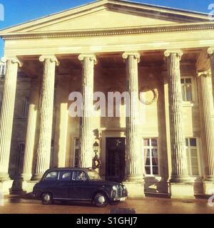 Imposing front facade of Luton Hoo country house hotel, with black taxi outside Stock Photo
